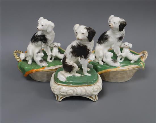 Two Staffordshire porcelain groups of a King Charles spaniel and puppies in a basket and a similar figure, c.1830-50, possibly Dudson,